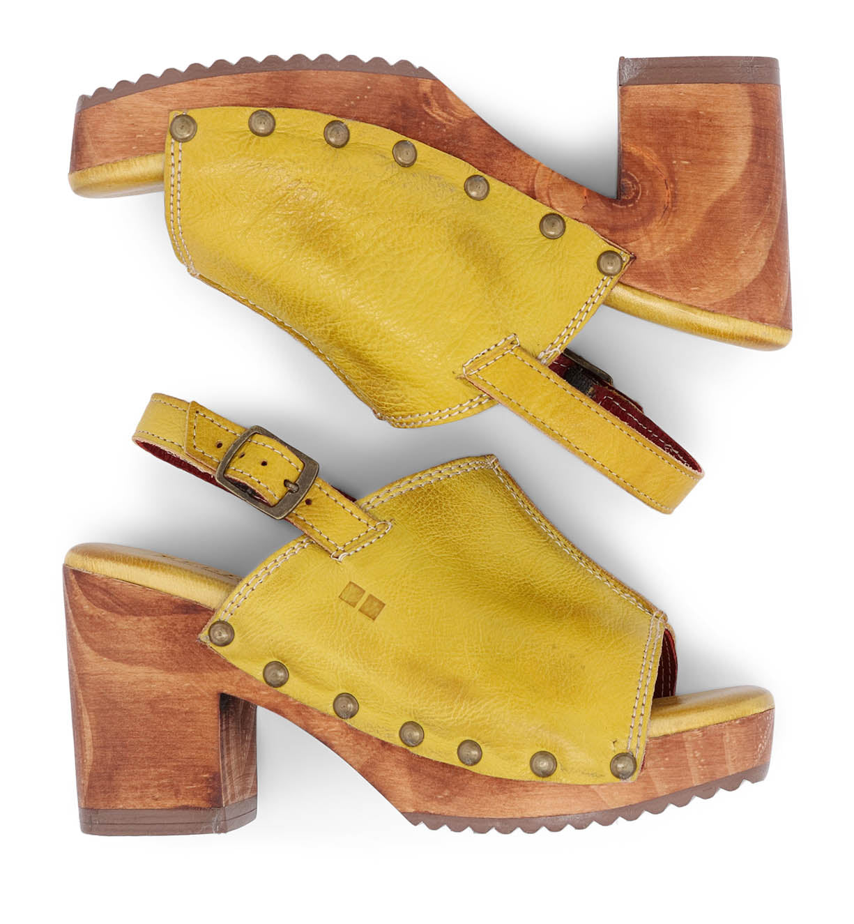 The Marie by Bed|Stü is a pair of yellow heeled clogs made from vegetable tanned leather, featuring sturdy wooden block heels, brass rivets, and adjustable ankle straps, shown in a side profile view.