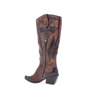 The Meadow boot by Bed|Stü features rich brown leather accented with black decorative stitching, a convenient side zipper, and a chunky angled heel. Inspired by handcrafted Italian boots, this stylish design offers a refined yet rugged look, beautifully displayed on a white background.