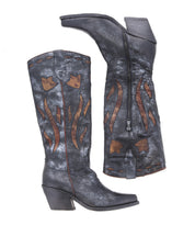 Step up your style with the Meadow boots by Bed|Stü—a tall pair of black leather cowgirl boots featuring brown flame-like decorative patterns, a convenient side zipper, and a chunky angled heel. These fashionable boots seamlessly blend classic western craftsmanship with modern flair.