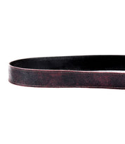 Close-up of the Bed|Stü Meander belt, crafted from dark brown leather with visible texture and stitching, displayed in a looped position against a white background.