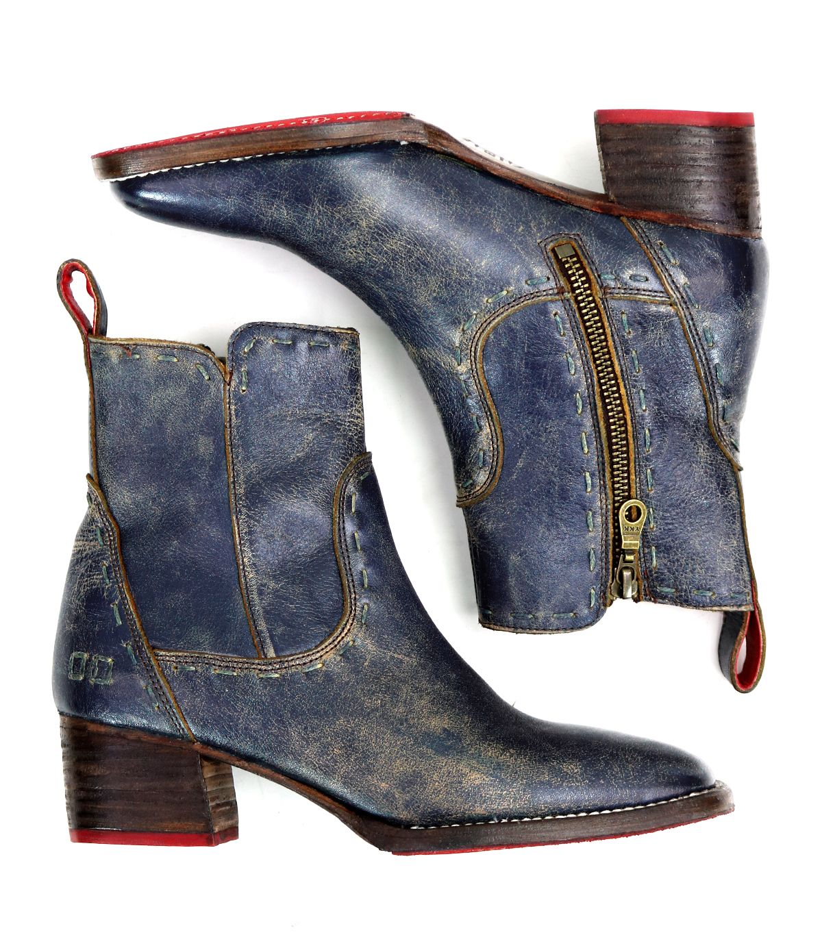 A pair of worn blue leather "Merryli" boots by Bed|Stü, featuring square toes, side zippers, red pull tabs, and low stacked wooden heels. These hand-stitched boots are shown from the side and bottom.