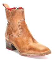 The Bed|Stü Merryli is a single worn brown leather ankle boot featuring a mid-height block heel, visible hand-stitched detailing, and a red inner lining, displayed at a three-quarter angle.