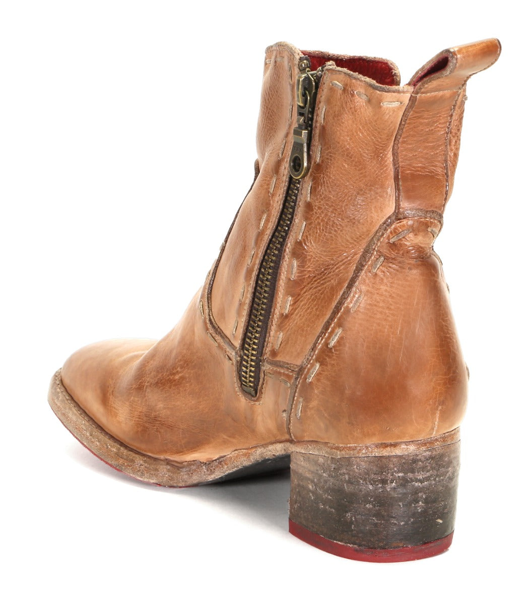 The Merryli by Bed|Stü is a hand-stitched brown leather ankle boot featuring visible stitching, a side zipper, and a chunky heel. Viewed from the back and side, this boot exemplifies classic craftsmanship and timeless style.