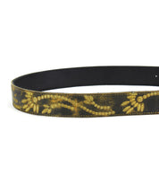 Introducing the Mohawk by Bed Stu: A distressed leather belt featuring an intricate gold floral design along its length.
