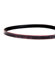 The Monae leather belt by Bed|Stü, featuring red-edged detailing and a classic buckle, is coiled in a partial circle against a white background—making it a stylish staple for any everyday wardrobe.