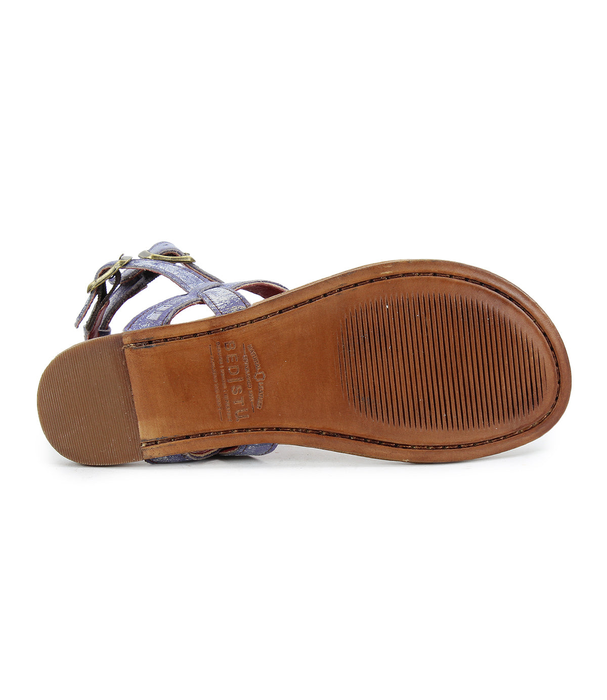 Bottom view of the Bed|Stü Moon leather sandal featuring a smooth brown sole with textured grip areas at the ball and heel, visible stitching, and part of the upper straps with an ankle buckle.