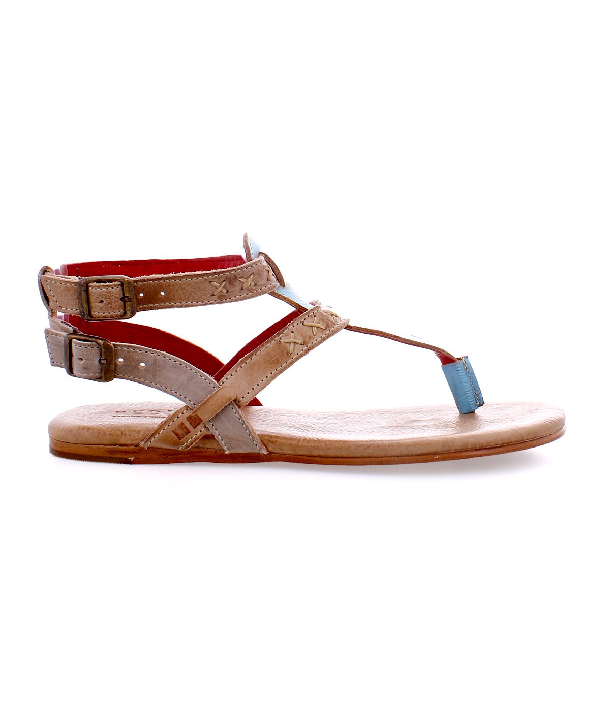 The Bed|Stü Moon sandal is shown in side profile against a white background, featuring tan leather construction, two ankle straps with metal buckles, a blue toe loop, and a cushioned insole.