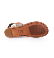 The Bed|Stü Moon sandal is shown from the bottom, featuring a tan and brown sole with a textured grip, a Bed|Stü brand stamp near the heel, and is designed for comfort with its cushioned insole.