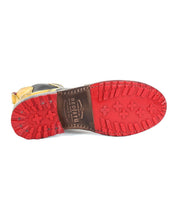 The image displays the bottom of the Nandi boot by Bed|Stü, highlighting its red rubber sole with a patterned tread and the "Bed|Stü" branding. This versatile Chelsea boot offers a slip-on design that merges style with comfort.