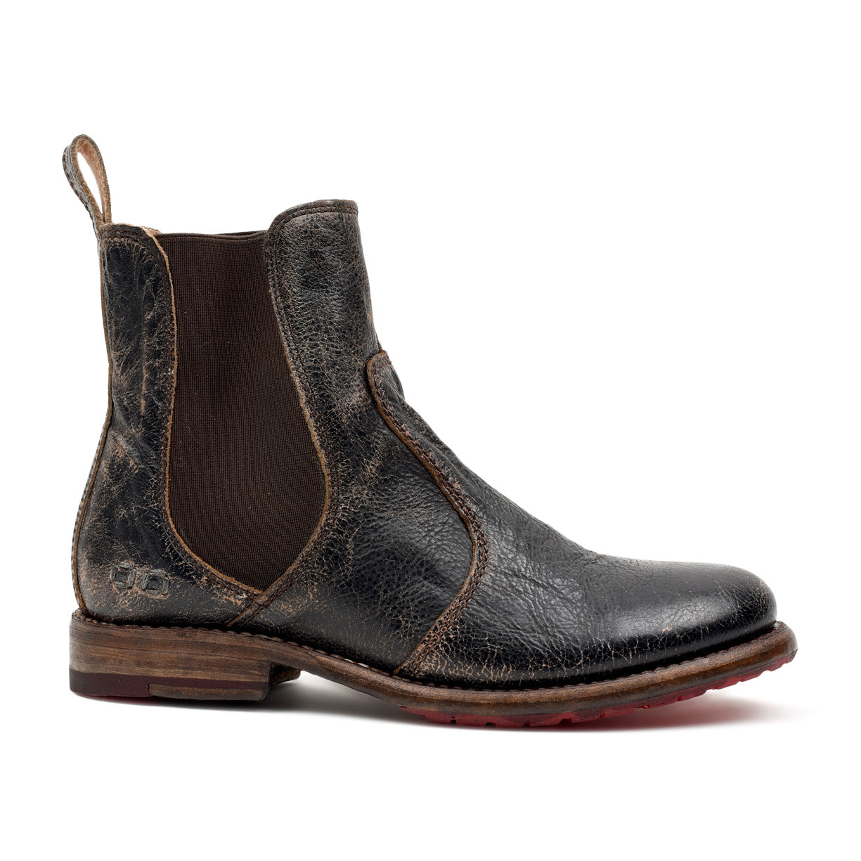 The Bed|Stü Nandi is a single worn black leather Chelsea boot with brown elastic side panels and a pull tab at the back, featuring a classic slip-on design, shown in profile on a white background.