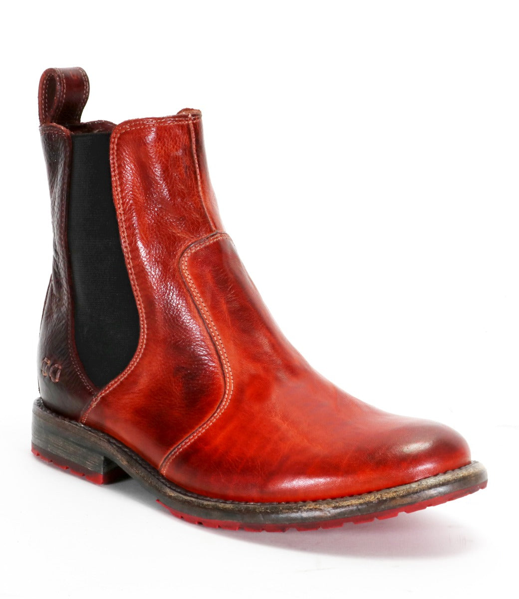 Introducing the Nandi boot by Bed|Stü: a single red leather Chelsea boot with black elastic sides, a pull tab at the back, and a brown sole accented by visible stitching. This versatile slip-on footwear is presented against a white background.