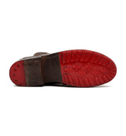 Bottom view of the Bed|Stü Nandi brown leather Chelsea boot, showcasing its red rubber sole with cross-shaped tread patterns and visible metal studs at the heel—highlighting its versatile appeal and convenient slip-on design.