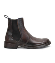 A single Nando Chelsea boot by Bed|Stü, crafted from hand-worked brown leather with black elastic side panels, a rear pull tab, and sturdy Goodyear welt construction, shown in a left side profile view.