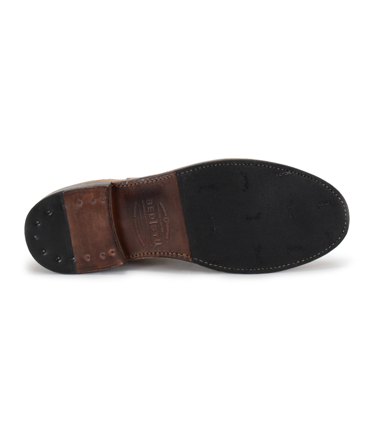The image displays the sole of the Nando Chelsea boot by Bed|Stü, showcasing a blend of leather and rubber with visible stitching and metal rivets near the heel, emphasizing its Goodyear welt construction for enhanced durability.
