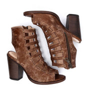 A pair of Bed|Stü Occam P brown distressed leather heeled sandals featuring open toes, cut-out sides, decorative X stitching, block heels, and visible side zippers, displayed on a white background.