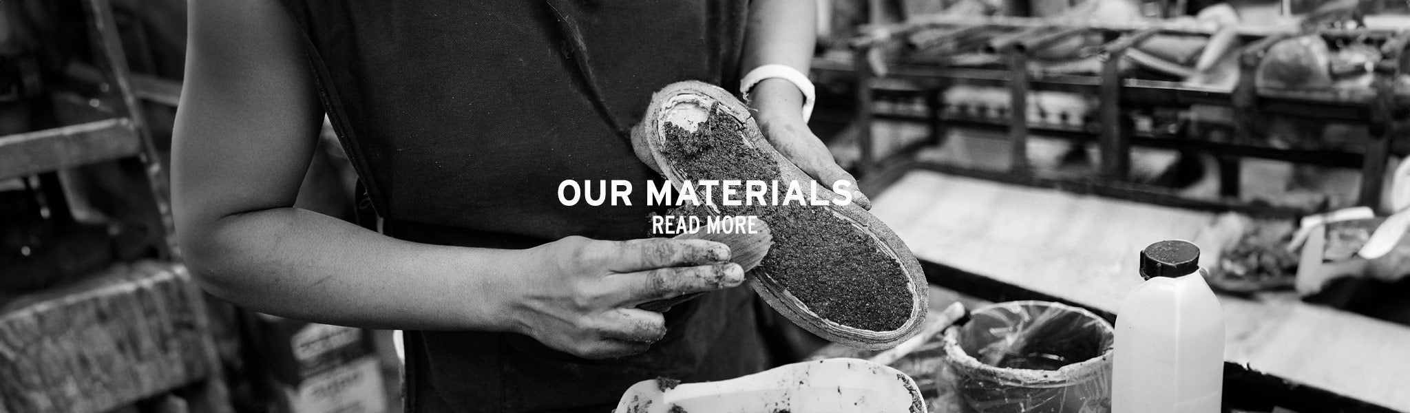 Black-and-white banner of a craftsperson working on a shoe, with the text “Our Materials” and “Read More.”
