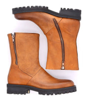A pair of Bed|Stü Ploy tan Italian leather mid-calf square toe boots with black lug soles and dual side zippers, displayed side by side on a white background.