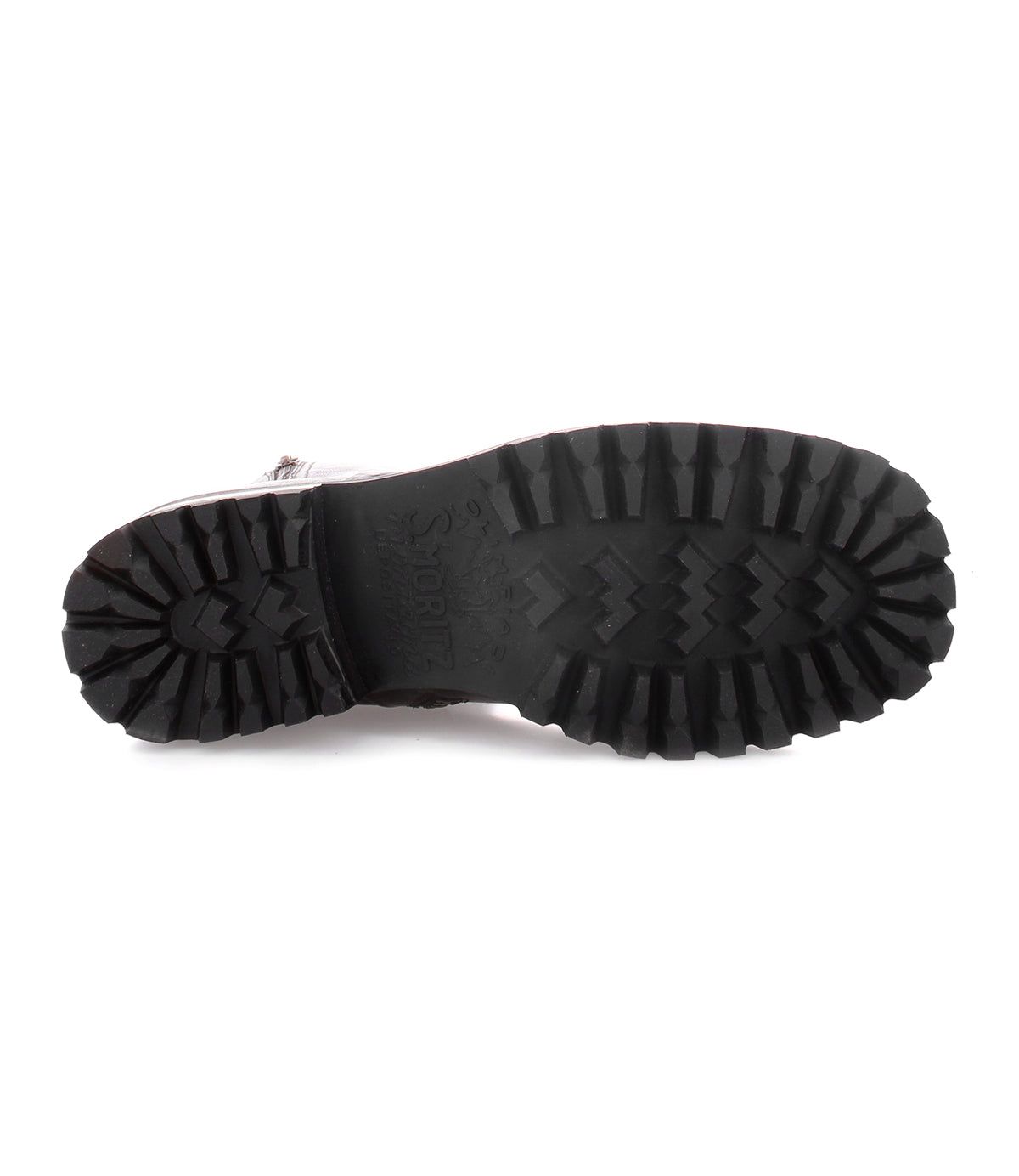 The image displays the bottom view of a single Bed|Stü Ploy boot in black Italian leather, emphasizing its thick, rugged tread pattern with deep grooves designed for superior traction.