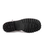 The image displays the bottom view of a single Bed|Stü Ploy boot in black Italian leather, emphasizing its thick, rugged tread pattern with deep grooves designed for superior traction.
