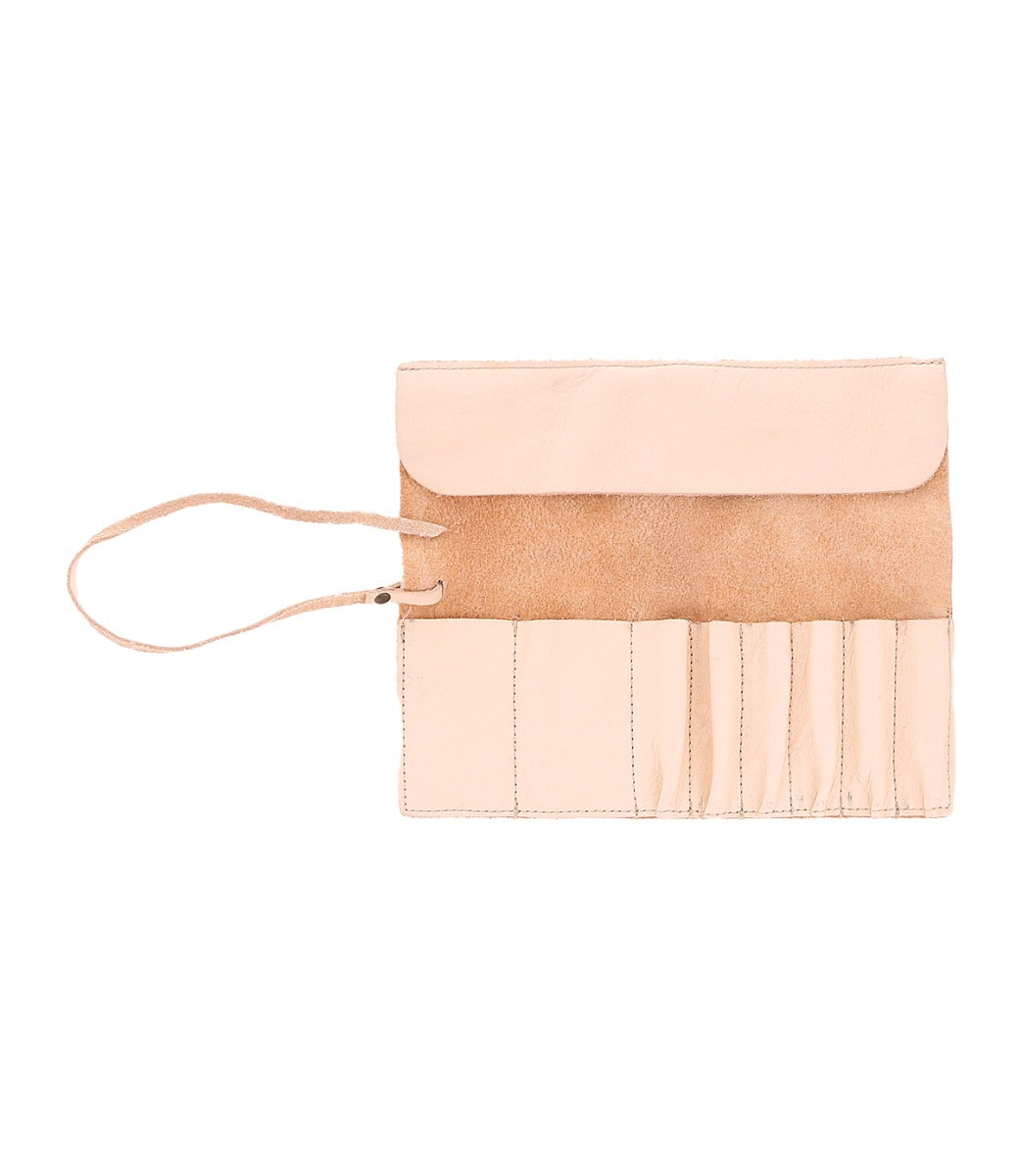 The Bed|Stü Prepped Leather Wrap is a light tan organizer featuring five narrow pockets, an open flap, and a slim leather tie on the left—perfect for artists who value both style and function.