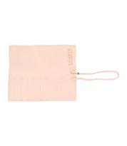 The Prepped Leather Wrap by Bed|Stü is a beige leather tool or brush roll featuring stitched slots and a tie closure, designed as an elegant organizer for artists, with the Bed|Stü logo in the top right corner.