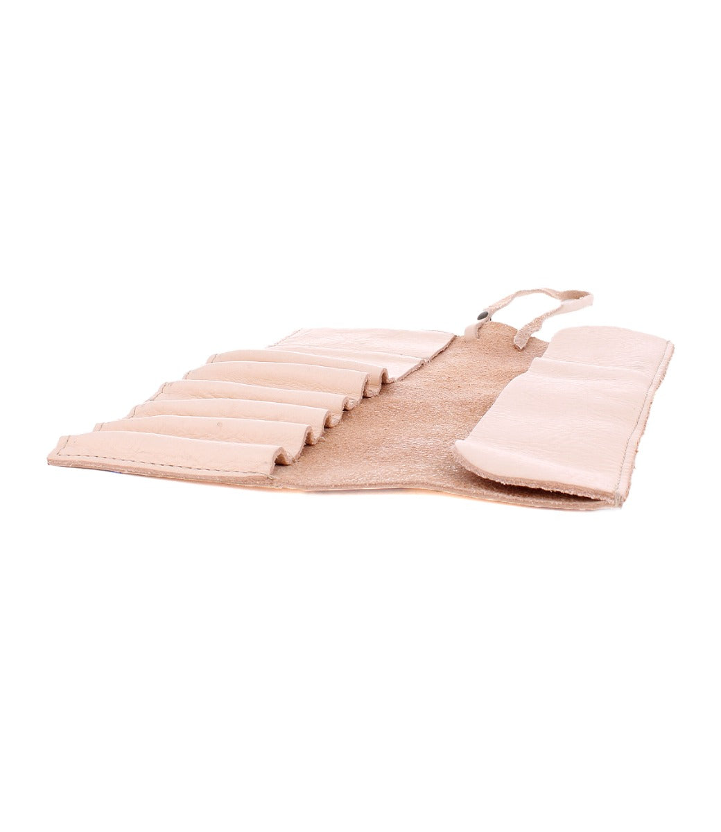 The Bed|Stü Prepped Leather Wrap, an open tan leather organizer with multiple slots for holding items, ideal for artists, is displayed on a white background.