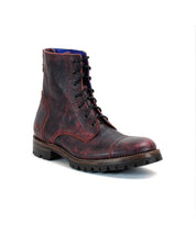 A Bed|Stü Protege Trek combat boot in red and black leather, featuring a textured finish, thick sole, Goodyear welt construction, and visible stitching, displayed on a white background.