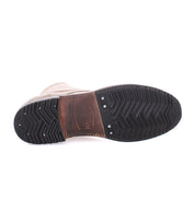 The underside of the Bed|Stü Protege dress shoe showcases a brown leather midsection and a black textured rubber sole, complete with tread patterns and metal rivets that evoke the durability of boots built with Goodyear welt craftsmanship.