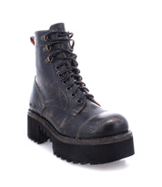 The Bed|Stü Prudence Hi is a black distressed leather lace-up combat boot featuring thick, chunky platform outsoles, metal eyelets, and visible stitching—shown angled on a white background for an edgy, standout style.
