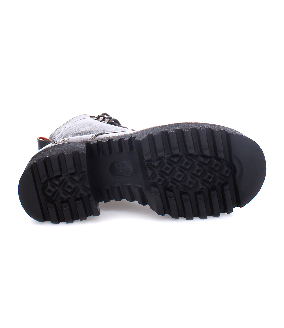 The Bed|Stü Prudence Hi, a black leather combat boot, is shown lying on its side against a white background, highlighting its chunky platform outsole and deeply textured rubber sole.