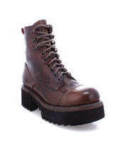 The Prudence Hi by Bed|Stü is a brown leather lace-up combat boot featuring a chunky platform outsole and a thick black treaded sole, displayed at a slight angle on a white background.