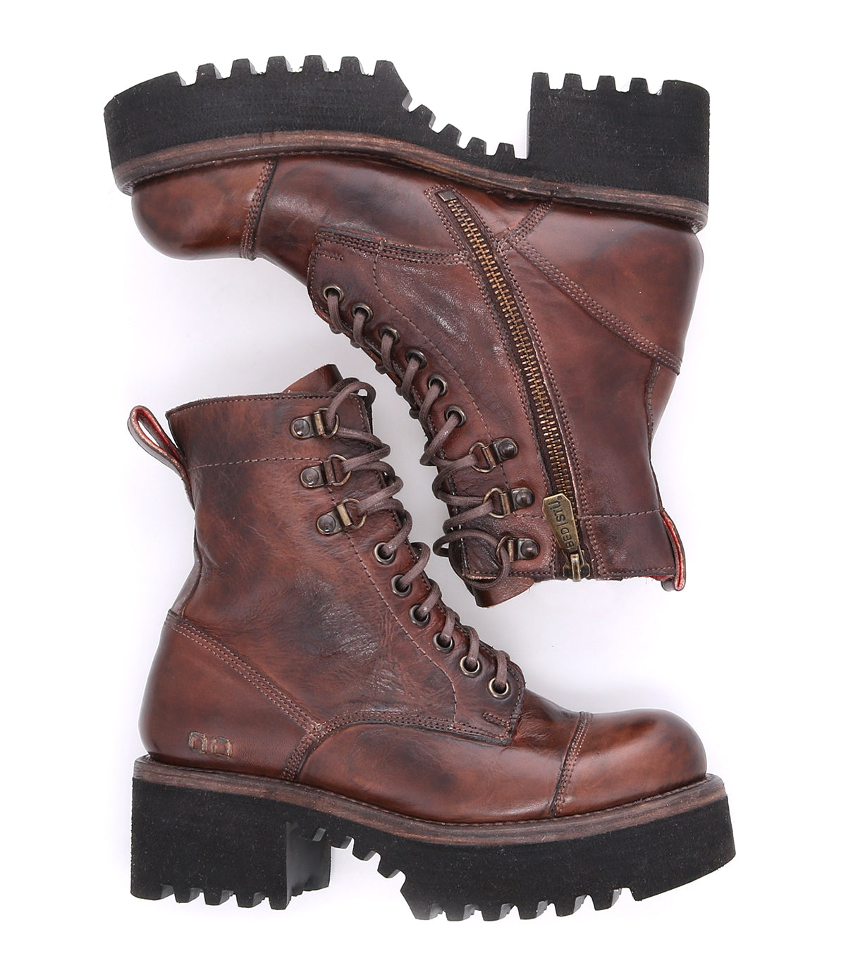 A pair of Bed|Stü Prudence Hi brown leather combat boots featuring thick black chunky platform outsoles, side zippers, and visible stitching, displayed against a white background.