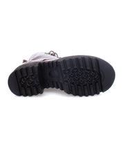 The image shows the bottom view of a single Bed|Stü Prudence Hi black leather combat boot, featuring a thick, rugged tread pattern on its chunky platform outsole.