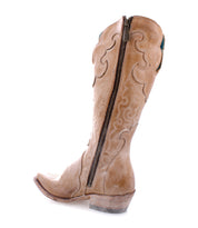 Bed|Stü "Queen" boot in tan vegetable-tanned leather, featuring decorative stitching, a side zipper, visible heel, and Fleur-de-lis accents along the side, photographed on a white background.
