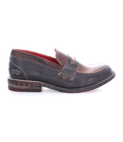 A single Reina loafer by Bed|Stü featuring Goodyear welt construction, a dark brown and tan color scheme, visible stitching, and a decorative metal detail on the heel.