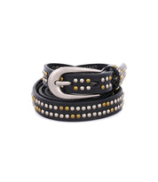 The Rico belt by Bed|Stü is a coiled black leather weekend accessory, adorned with silver and gold metallic studs and finished with a shining silver buckle, displayed against a white background.