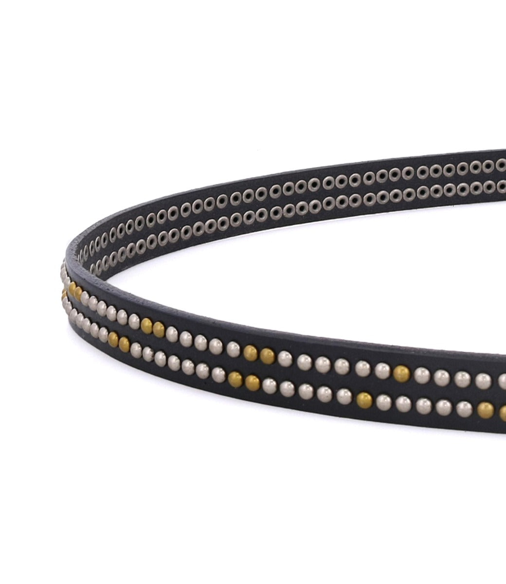 Close-up of the Rico black leather weekend belt by Bed|Stü, adorned with rows of small gold and silver metallic studs and featuring a sleek silver buckle, set against a white background.