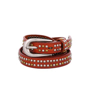 Introducing Rico by Bed|Stü—a brown leather weekend belt adorned with silver and brass metallic studs and finished with a sleek silver buckle, elegantly coiled in a circular shape against a white background.