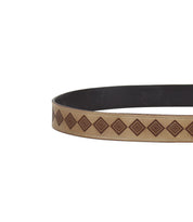 The Bed|Stü Roam features a brown leather strap with a tan stripe and a repeating geometric diamond pattern, showcasing western artistry, partially shown in the image on a white background.