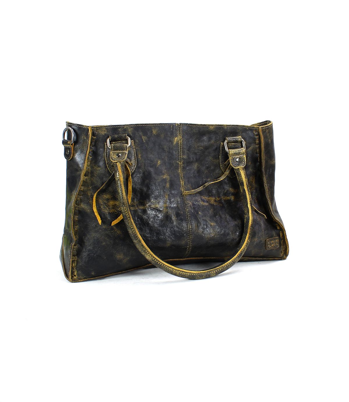 The Bed|Stü Rockababy is a dark brown distressed leather tote bag with dual handles, decorative side straps, visible stitching, and a weathered finish—crafted from vegetable-tanned leather—shown against a white background.