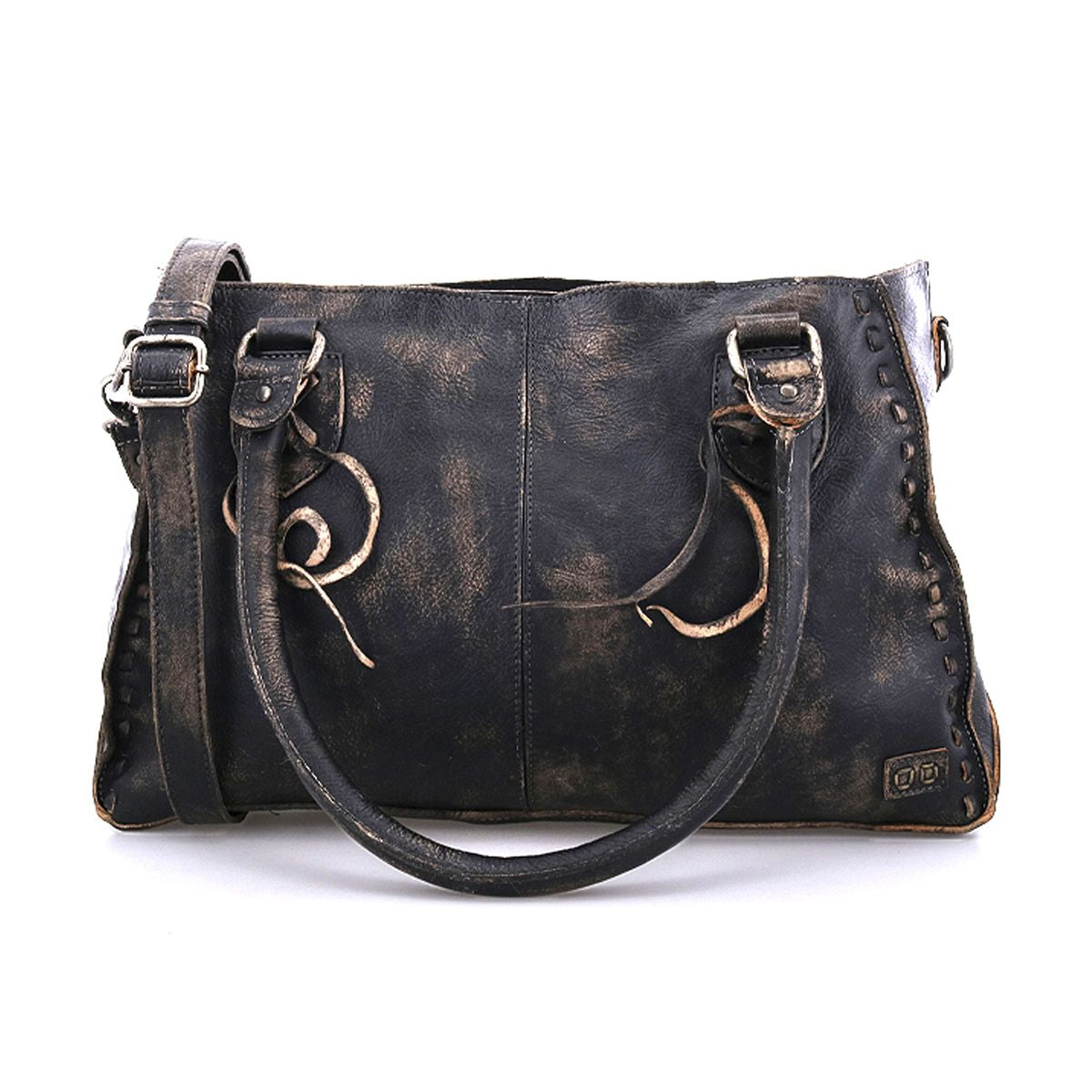 The Rockababy by Bed|Stü is a distressed black compact leather bag, made from vegetable-tanned leather and shown against a white background. It features two handles, a crossbody strap, decorative stitching, and metal rings.
