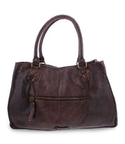 The Bed|Stü Rockaway is a dark brown full-grain leather handbag featuring double handles, a front zipper pocket, and stitched edge detailing for everyday function, shown against a white background.
