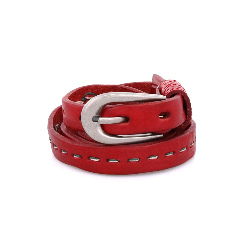 The Bed|Stü Ruby belt, crafted from smooth red leather with contrast stitching and finished with a silver metal buckle, is displayed against a white background.