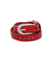 The Bed|Stü Ruby belt, crafted from smooth red leather with contrast stitching and finished with a silver metal buckle, is displayed against a white background.