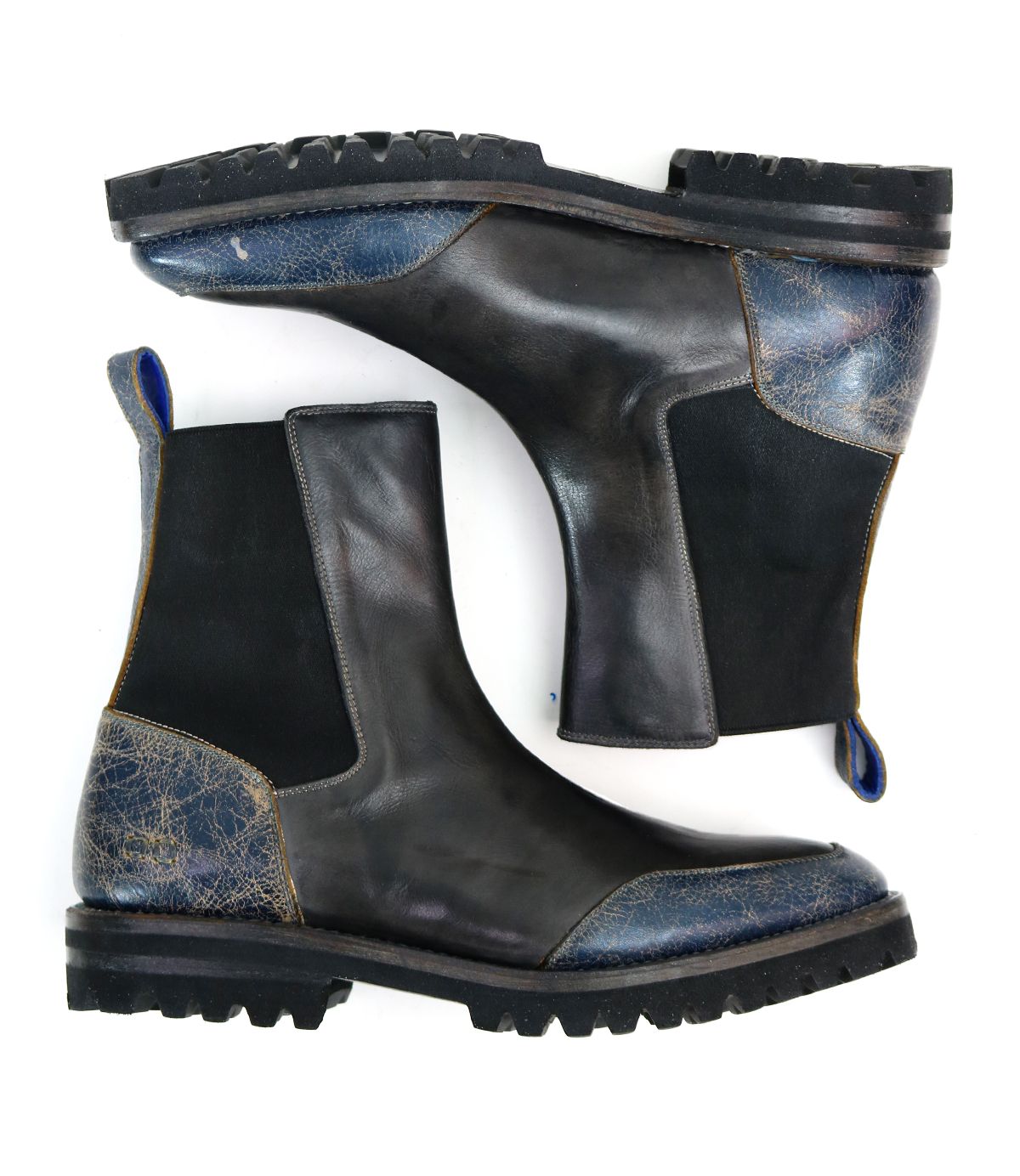 Salatiel by Bed|Stü: A pair of black leather Chelsea boots featuring textured blue accents on the heel and toe, black elastic side panels, and thick rubber soles with a textured outsole. Displayed side by side on a white background, these boots include a cushioned leather footbed for lasting comfort with every step.