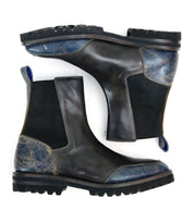 Salatiel by Bed|Stü: A pair of black leather Chelsea boots featuring textured blue accents on the heel and toe, black elastic side panels, and thick rubber soles with a textured outsole. Displayed side by side on a white background, these boots include a cushioned leather footbed for lasting comfort with every step.