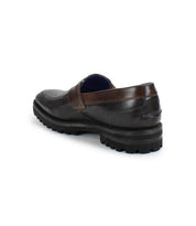 A single Samosa men's penny loafer by Bed|Stü in dark brown, featuring a thick black sole, shown from a back side angle against a white background.