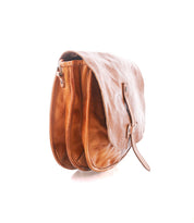 A light brown Sequoia EM vegetable-tanned leather saddlebag by Bed|Stü, featuring a buckle strap and two main compartments, is shown on a white background.