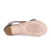 The image shows the bottom view of the Bed|Stü Soto sandal, featuring a single cutout leather design with a light-colored sole, visible stitching, and textured grip areas at the toe and heel—perfect for everyday exploring.