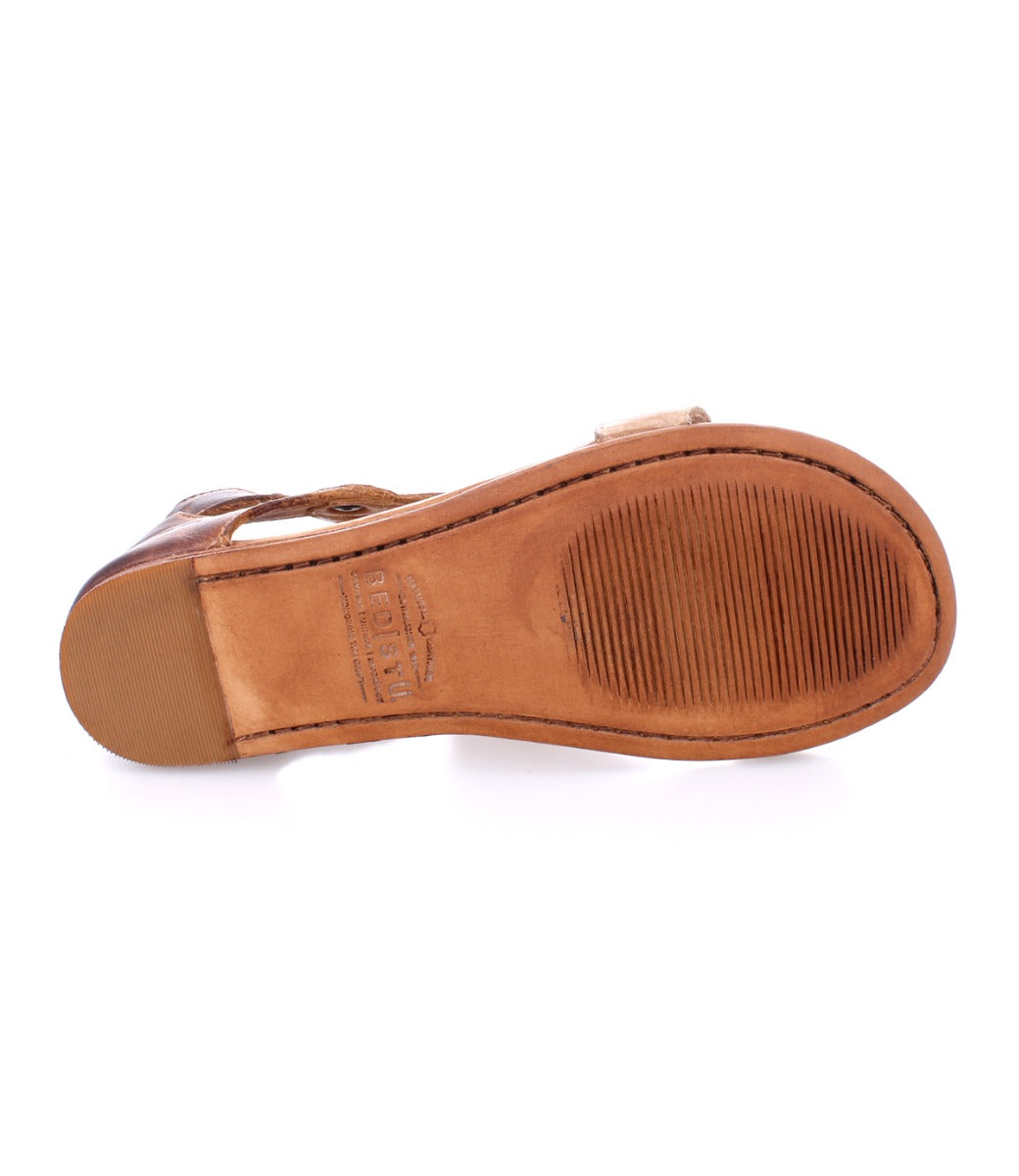 The underside of the Bed|Stü Soto brown leather sandal reveals a smooth sole with a textured section near the front and detailed edge stitching, thoughtfully designed for everyday exploring. This cutout leather sandal also features a cushioned footbed, ensuring comfort with every step.